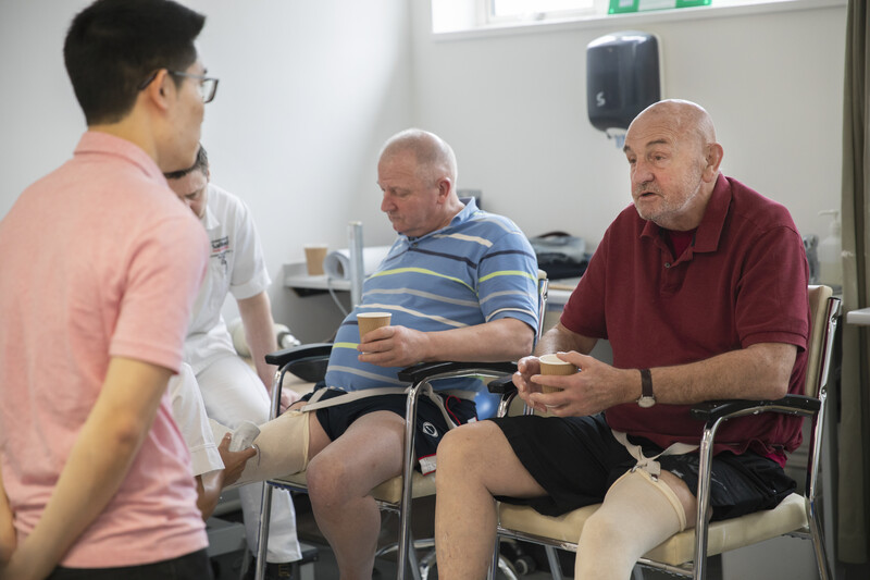 Men being fitted for prosthetic legs