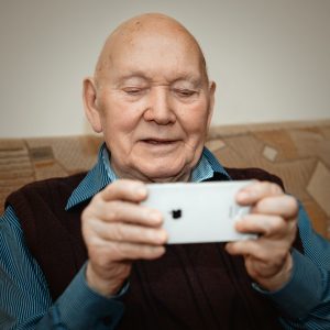 Old man holding phone landscape