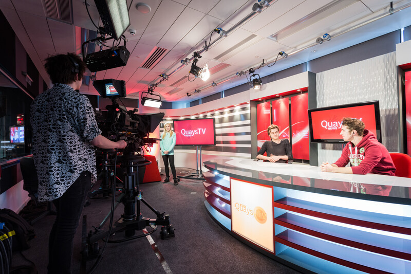 Students filming in a broadcast studio