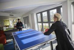 Students playing table tennis in Peel Park Quarter student accommodation
