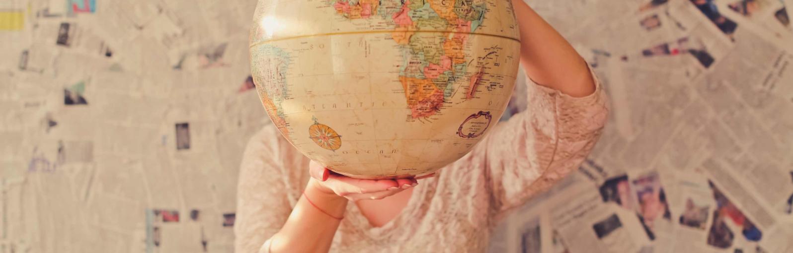 A person holding a globe